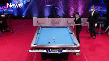 a pool table with a sign that says news on it