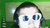 a close up of a person wearing headphones and sunglasses