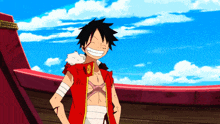 monkey d luffy from one piece is smiling and standing in front of a red boat