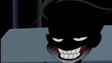 the joker from the batman animated series is smiling and making a funny face in the dark .