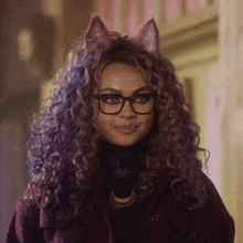 a woman with curly hair and cat ears is wearing glasses and a necklace