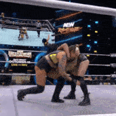 two women are wrestling in a wrestling ring with a new rampage sign behind them