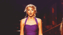 a woman in a purple dress looks surprised