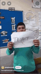 a man holds up a sign that says tesbit x