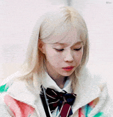 a girl with blonde hair is wearing a tie and a jacket