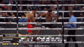 two boxers are fighting in a ring with a t mobile logo on the side