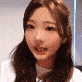 a close up of a woman 's face with a white shirt that says i love you