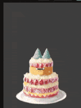 a birthday cake with a pink bow and a candle that says selamat atas launching nya one love commu