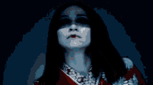 a close up of a woman 's face with a red light coming from her eyes .