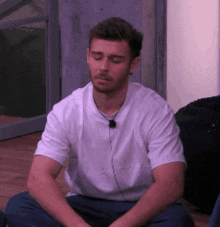 a man wearing headphones sits with his eyes closed