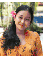 a woman with a flower in her hair is smiling