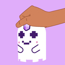 a hand is holding a white ghost with purple crosses on it