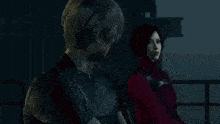 a man and a woman are sitting next to each other in a dark room and looking at each other .