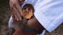 a picture of a man with a mustache is being held in someone 's arm