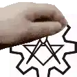 a person 's hand is holding a pentagram on a white background .
