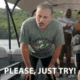 a man wearing a t-shirt that says " nobody at the lake " is on a boat and says please just try