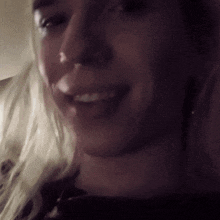 a close up of a woman 's face with a blurred background