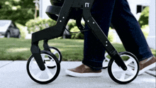 a person is pushing a stroller that has the letter n on the front