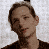 a close up of a young man 's face with his eyes closed