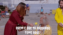 a woman in a red dress is talking to a man in a yellow suit who is holding a microphone