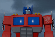 a red and blue robot with a transformer logo on its chest