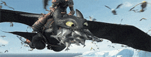 toothless from how to train your dragon is riding a dragon in the air