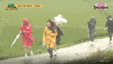 a group of people walking in the rain with u + dream sups written on the bottom of the screen