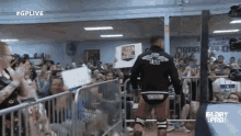 a man in a wrestling ring holds a sign that says brian price