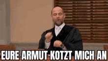 a man in a judge 's robe is standing in front of a podium and making a funny face .