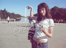 a woman stands in front of a washington monument with the words boy turn that clairo off and go grab urself a beer below her