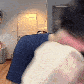 a blurry picture of a person sitting on a couch with a door in the background