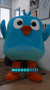 a blue bird mascot is standing in front of a wall that says every dog has its day