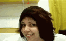 a woman with red hair and a nose ring smiles for the camera