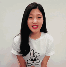 a woman wearing a white t-shirt with a rabbit on it