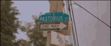 a street sign for pastorius st. has an arrow pointing right
