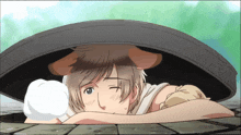 a man with a dog 's ears on his head is laying down