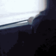 a person is looking out of a window with a white background