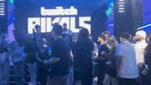 a crowd of people standing in front of a twitch rivals sign