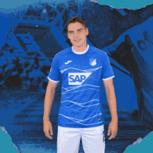 a man is wearing a blue shirt with the word sap on it