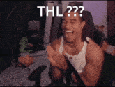 a man with dreadlocks is laughing and clapping with the words thl on his face