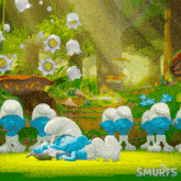a group of smurfs laying on the grass in a forest