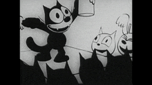 a black and white cartoon of felix the cat with a bucket