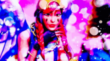 a woman with red hair and a braid is standing in front of a pink and blue background .