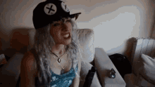 a woman is wearing a hat with a cross on it
