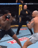two men are fighting in a boxing ring with a corona advertisement on the fence