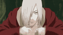 a man with long white hair is wearing a red hoodie