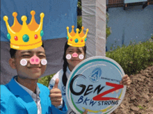 a boy and a girl wearing crowns holding a sign that says genz bkw strong