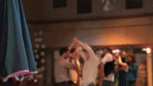 a blurry picture of a group of people dancing in a club