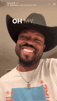 a man wearing a cowboy hat and a shirt that says oh my on it