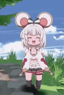 a little girl with a bow on her head is standing in a field with her eyes closed